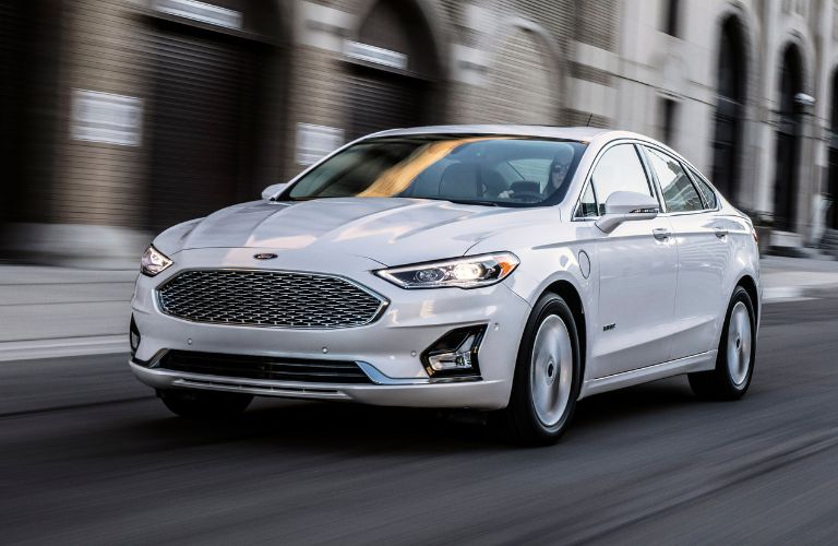 A white 2020 Ford Fusion on the road
