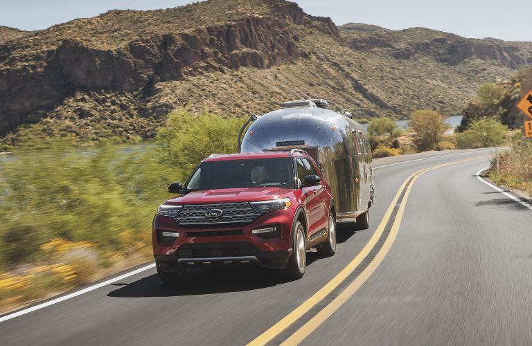 a red 2021 Ford Explorer towing a trailer