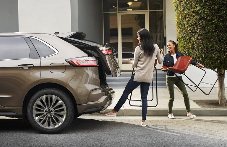 Women loading the cargo space of the 2021 Ford Edge