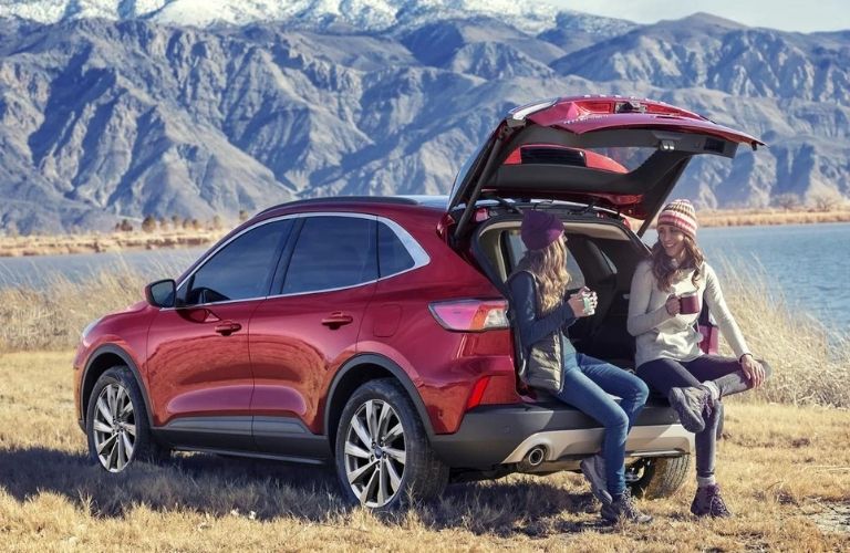 Women sipping coffee while enjoying some chat in the 2023 Ford Escape Cargo Space