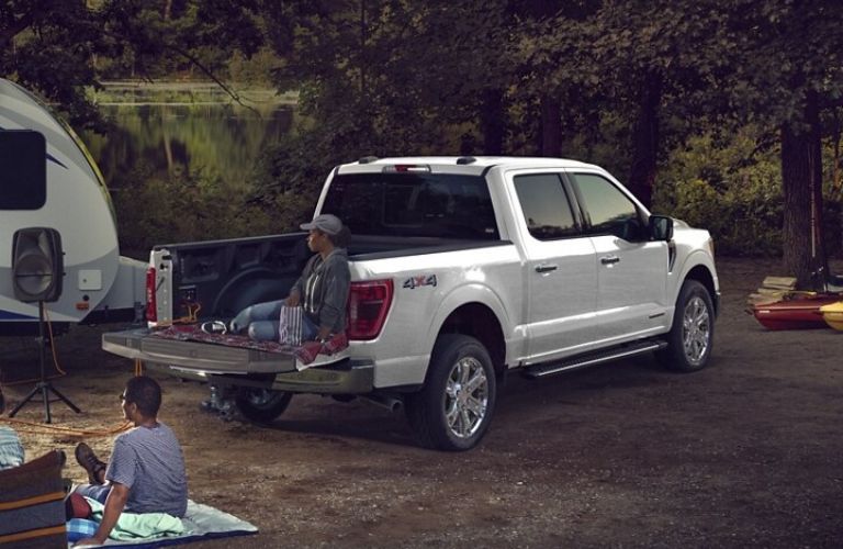 Person Sitting in the Bed of 2024 Ford F-150 at a Campsite