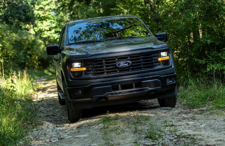 Black 2024 Ford F-150 STX Front on a Dirt Road