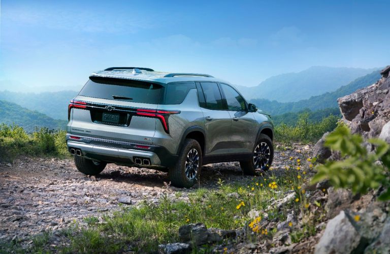 Gray 2024 Chevy Traverse Rear Exterior on a Mountain Trail