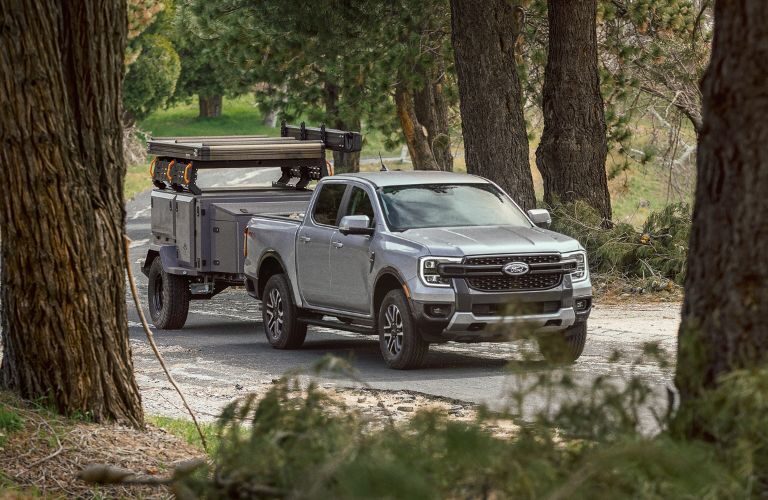 Gray 2024 Ford Ranger Towing a Trailer on a Wooded Road